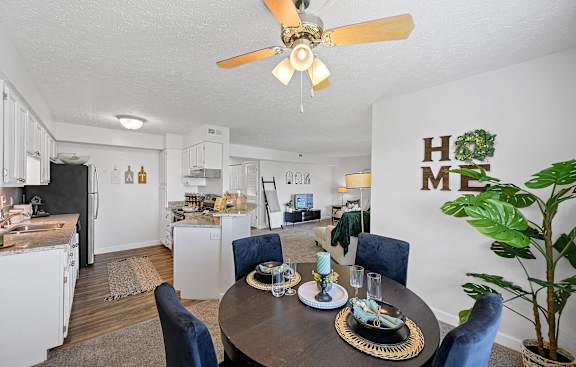 a dining area with a table and chairs and a kitchen in the background at Wrights Point, Kentucky, 41011