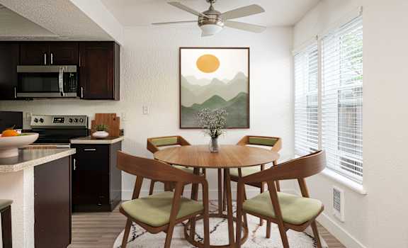 A dining room with a table set for four.
