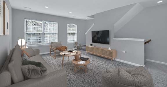 a living room filled with furniture and a flat screen tv