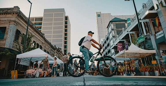 A man riding a bicycle in a city street.