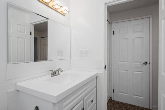 a bathroom with a sink and mirror