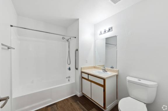 a bathroom with a toilet sink and shower