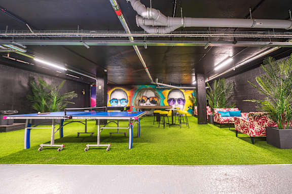 a pool table and ping pong table in the games room