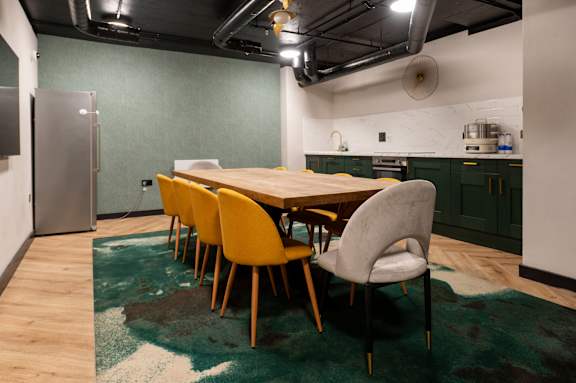 A dining room with a table and chairs.