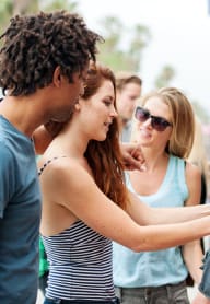 a group of people looking at clothes in a store