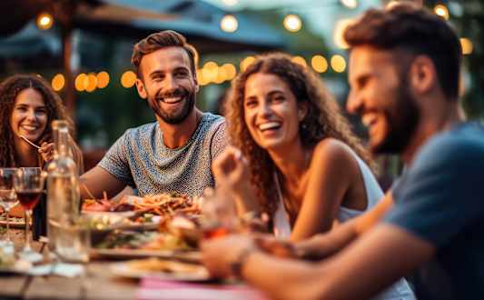 Four people enjoying a meal together at a restaurant.