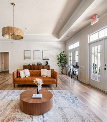 A living room with a brown coffee table and a rug.