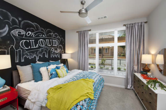 a bedroom with a large bed and a chalkboard wall at Marley EAV, Atlanta, GA