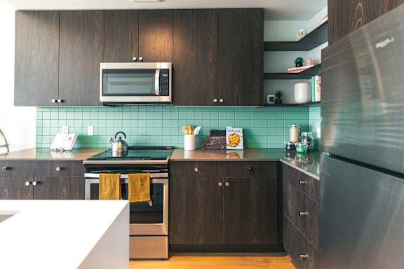 A kitchen with a stove, oven, and refrigerator.