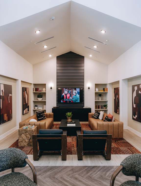 A living room with a large couch, a coffee table, and a television. at Northwoods, Texas, 77388