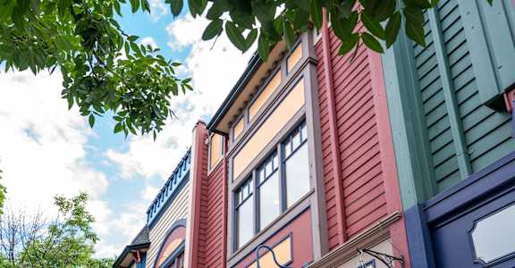 A building with a sign that says "Aldea Cafe" on it.