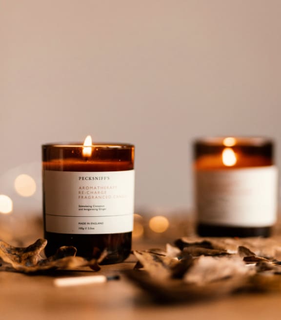 Two Candles on Table with Leaves