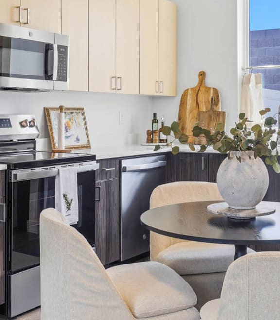 A modern kitchen with a table and chairs.