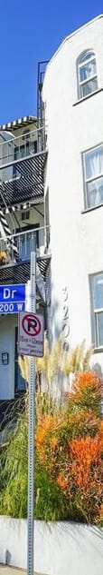 a white building with a street sign in front of it