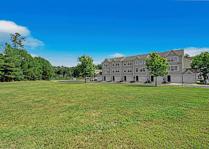 a large grassy area with a large building in the background