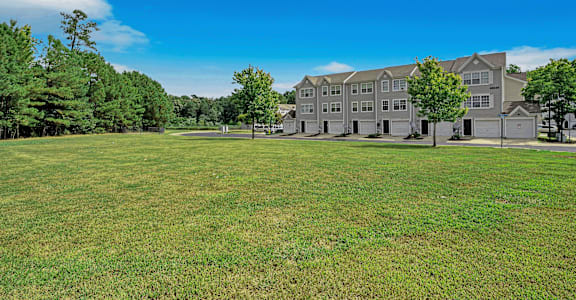 a large grassy area with a large building in the background
