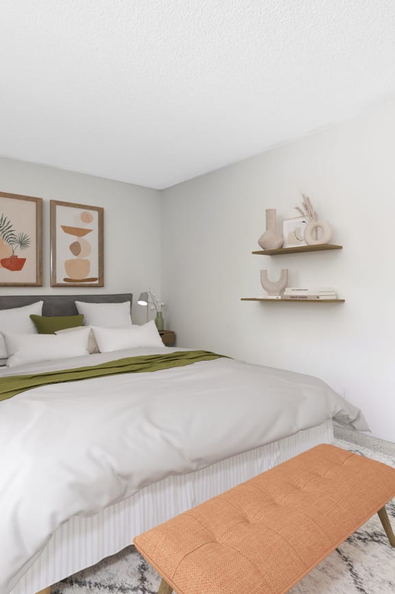 a bedroom with a white bedspread and green blanket
