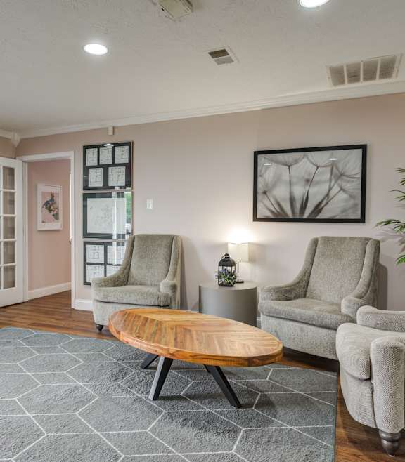 a living room with two chairs and a coffee table