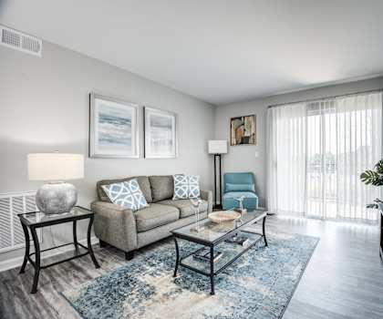 our apartments offer a living room with a couch and a tv