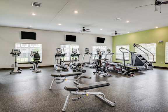 a gym with treadmills and other exercise equipment