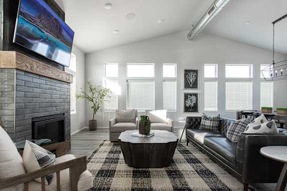 A modern living room with a fireplace and a flat screen TV mounted above it.