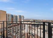 Thumbnail 26 of 26 - A view from a balcony overlooking a city street.