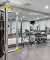 fitness center with a weight machine, dumbbells, and a bench at the Vue apartments in Indianapolis