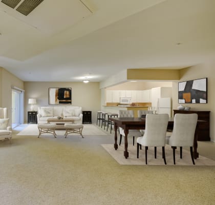 a living room and dining room with white furniture and beige carpet at Tesoro Senior Apartments, California