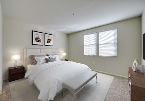 A bedroom with a large bed and two framed pictures on the wall. at Sonoma at Porter Ranch, Porter Ranch, 91326