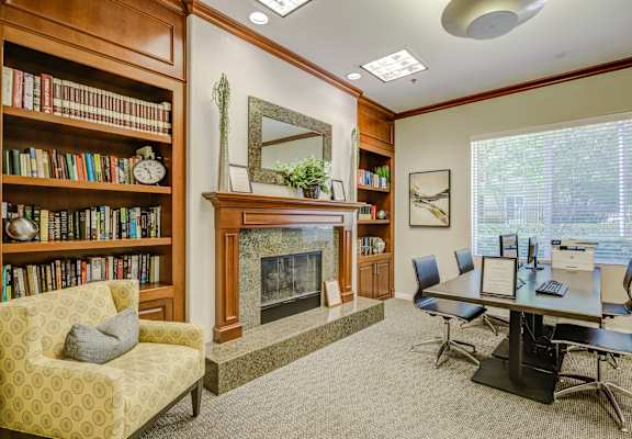 a room with a fireplace and a table and chairs