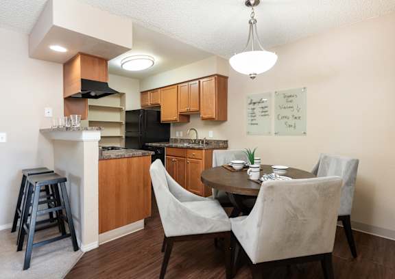 an open kitchen and dining area with a table and chairs and a kitchen counter top