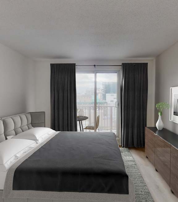 A bedroom with a large bed and a balcony.