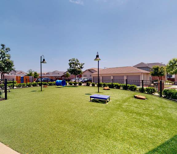A park with a bench and a baseball diamond.