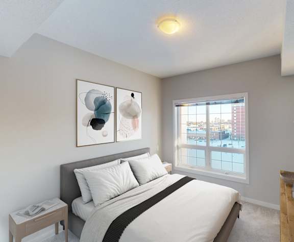 A bedroom with a large bed and a window overlooking a city.