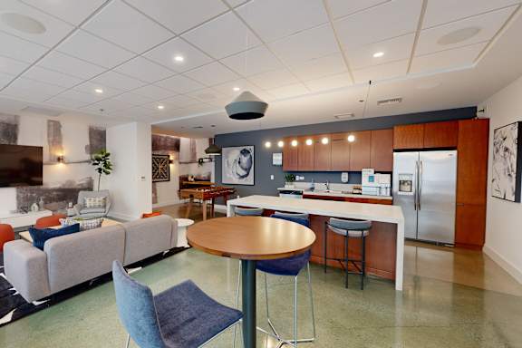 A modern living room with a grey sofa and a round table.