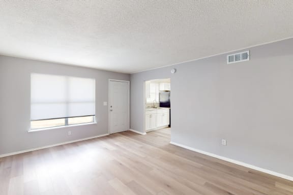 a bedroom with hardwood floors and grey walls at Lakeland Manor Apartments