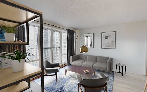 A living room with a grey sofa, a coffee table, and a large window.