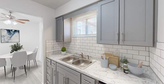 an open kitchen and dining room with a table and a sink