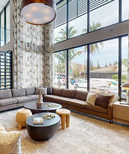a living room with a large stone pillar and a large couch