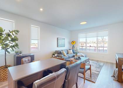 A living room with a dining table and chairs.