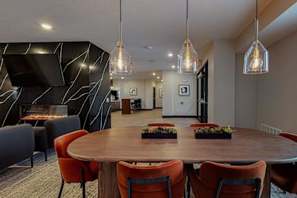 A modern dining room with a round table and chairs.
