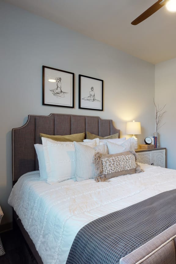 a bedroom with a large bed and a ceiling fan Matthews, NC 28105