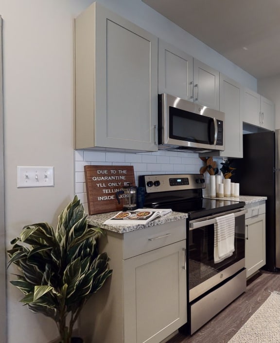 a kitchen with stainless steel appliances and a clock on the wall Matthews, NC 28105