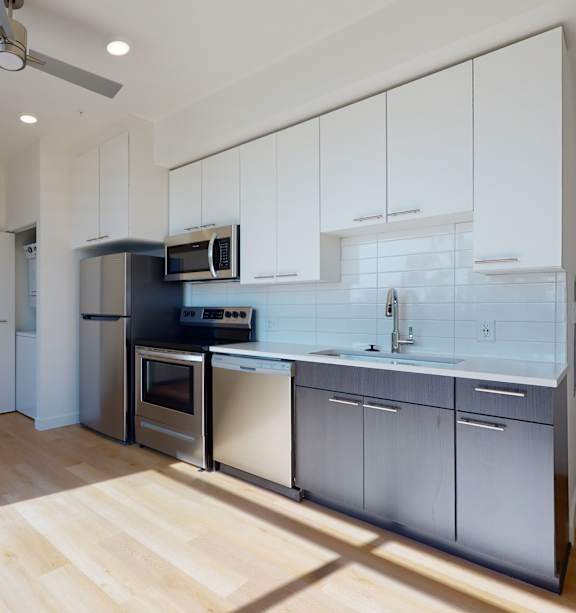 Kitchen with White Cabinets at Proto Apartments, Denver, 80204