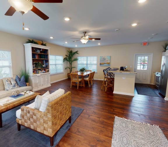 a living room with a couch and a chair and a kitchen at River Oaks, Little River