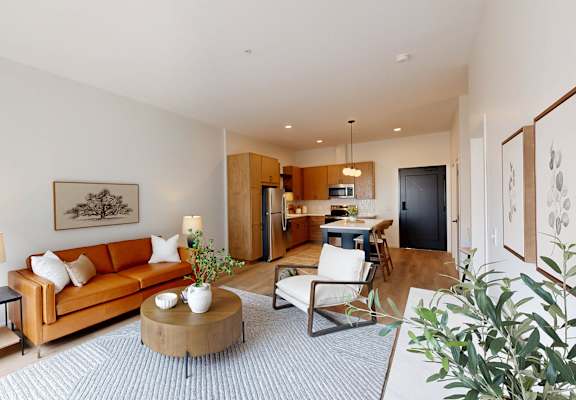 A living room with a couch, a coffee table, and a lamp.
