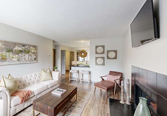 A living room with a white sofa and a coffee table. at Karric Place of Dublin Apartments, Ohio, 43016