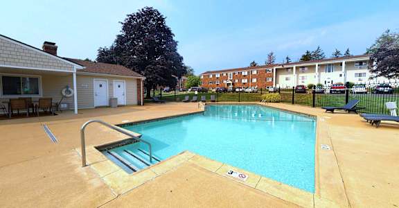 a swimming pool with a building in the background