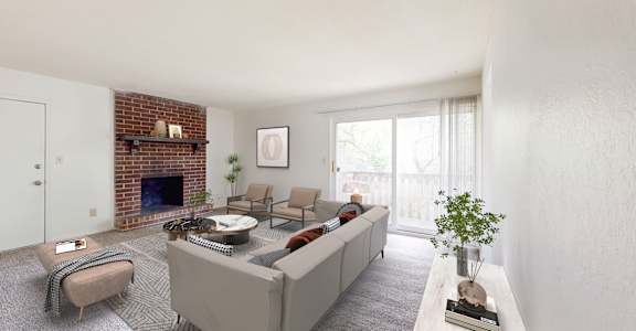 a living room with a white couch and a brick fireplace