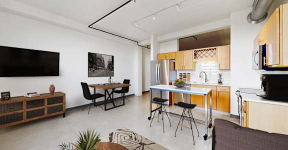 A modern kitchen with a dining table and chairs.